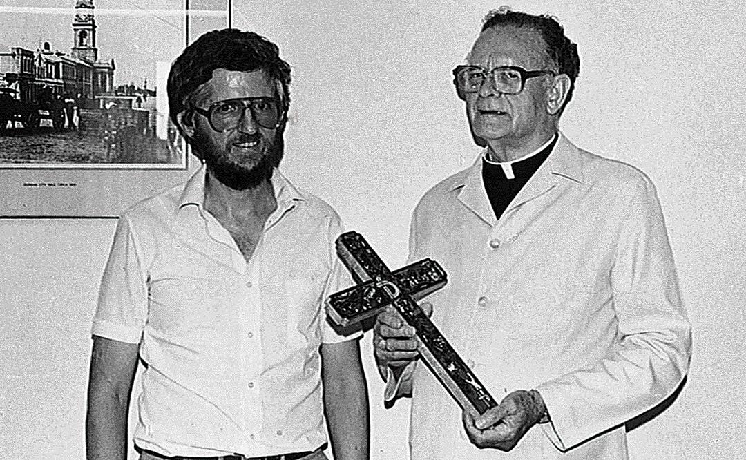 Arch. Hurley giving Kearney a cross from El Salvador at Diakonia office, Durban, 1976.