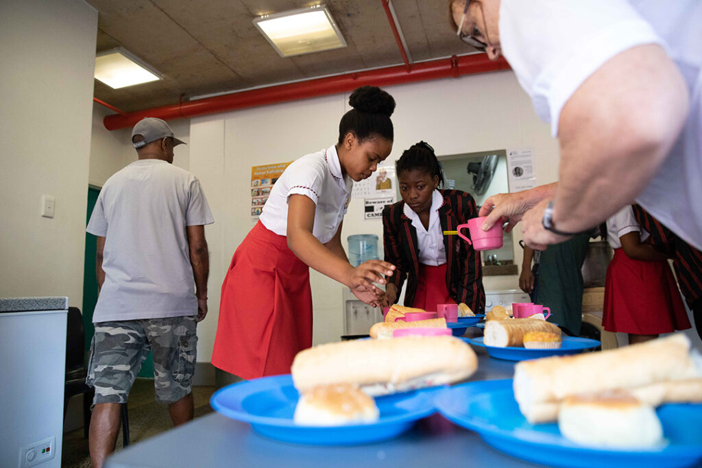 Young people from the Holy Family College in Durban, volunteering in food preparation for the homeless at DHC.